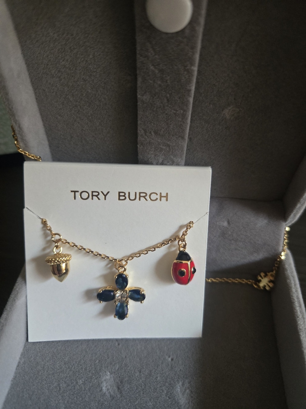Tory Burch Gold Charm Necklace with Red Ladybug & Blue Gem Flower